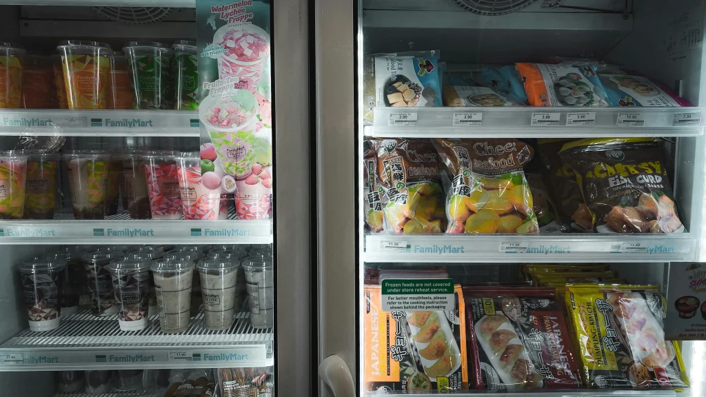 コンビニの扉式冷蔵庫に商品が並ぶ姿